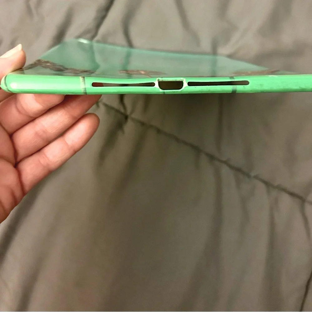 I pad cover green w Palm tree pattern. Silver text